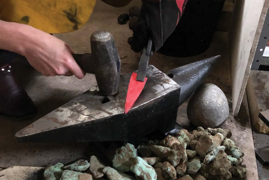 Copper native to the Upper Peninsula of Michigan becomes brittle with repeated hammering, so heating the materials and shaping them—known as annealing—is an essential component of copper tool production. Here, Bebber shapes annealed copper into a point. Photo: Bob Christy / Courtesy of Kent State University