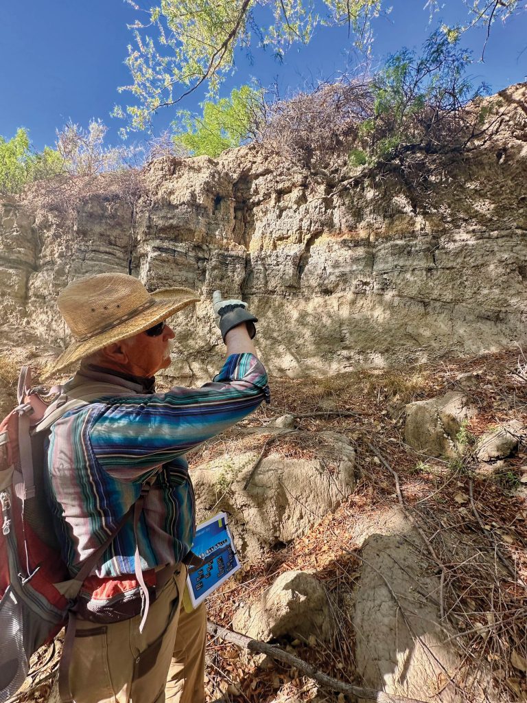 Archaeologist David Greenwald discusses the stratigraphy at Creekside Village, which shows the Rio Tularosa maintained steady flow through the late Holocene, creating slow-moving waters and riparian wetlands. Between A.D. 300–900, the area shifted from moist, winter-dominated vegetation to a drier, summer-moisture regime—likely due to canal construction that diverted water for irrigation and drained wetlands for farming. By about A.D. 1100, two centuries after Creekside Village was abandoned, the floodplain returned to its earlier ciénega wetland state. Photo by Tamara Jager Stewart