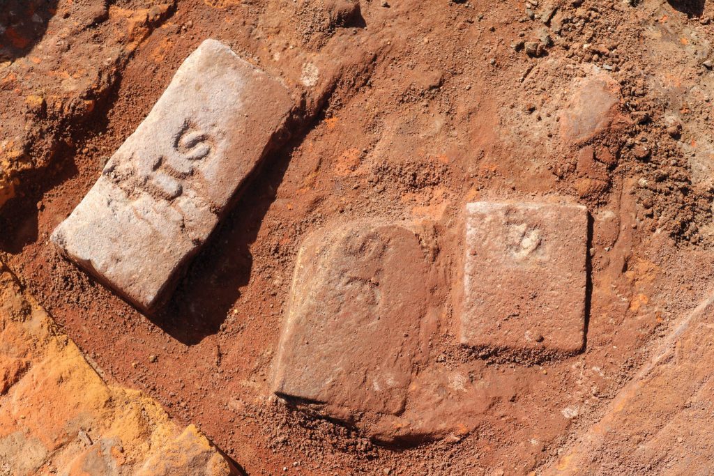 Several artifacts recovered from the Upper Eimer Sugarhouse excavations included stamped bricks. Photo by Cat Strader.